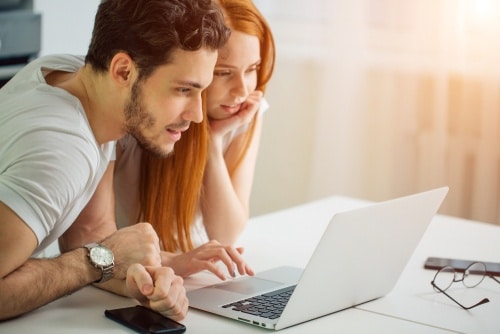 young couples book travel deals online
